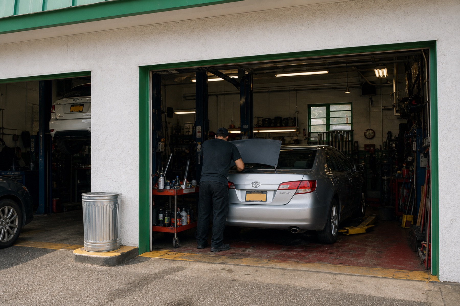 Mechanic working from behind on an everyday customer car at One Broadway Auto